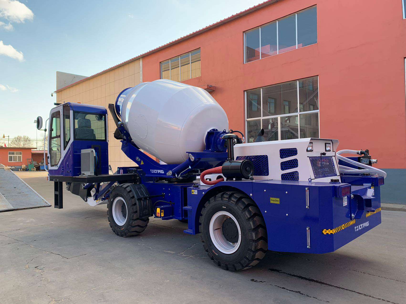 Self-loading concrete mixer